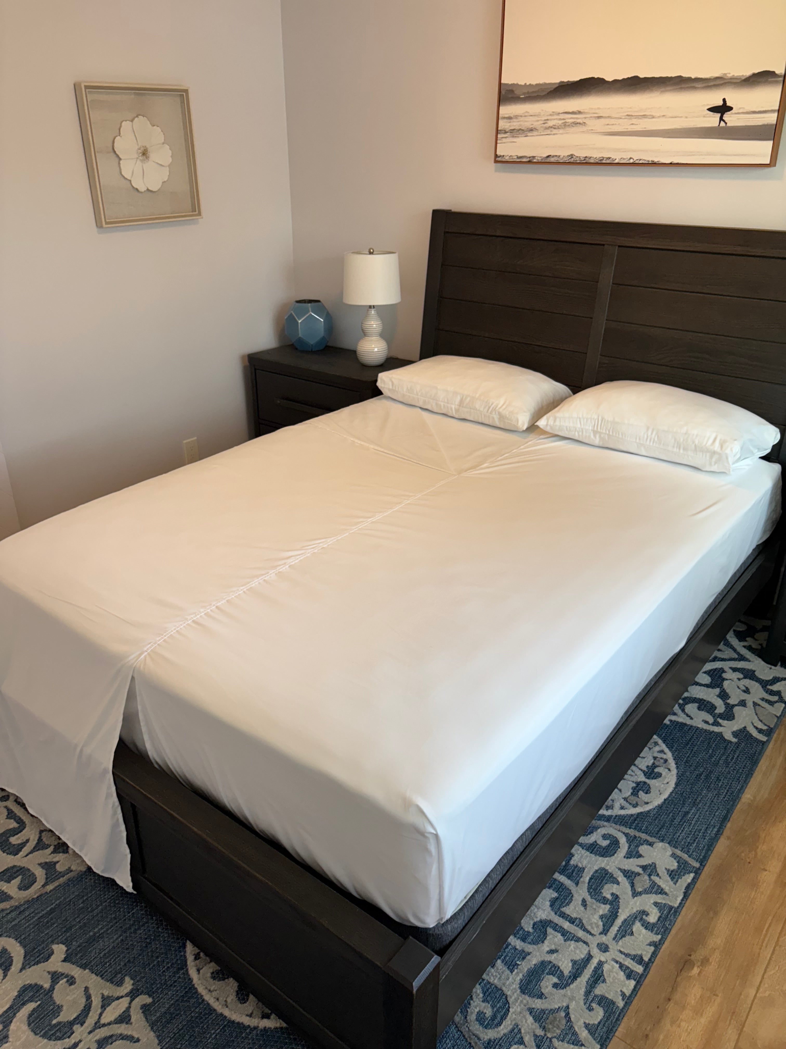 Load video: How to make a bed using Butterfly Sheets featuring connected flat and fitted sheets for couples.